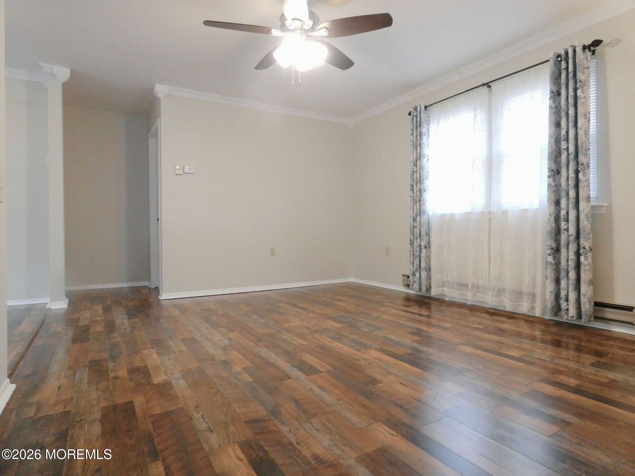 33D Medford Road, Unit A Manchester Township, NJ 08759 - Photo 5 of 24 an empty room with wooden floor fan and windows