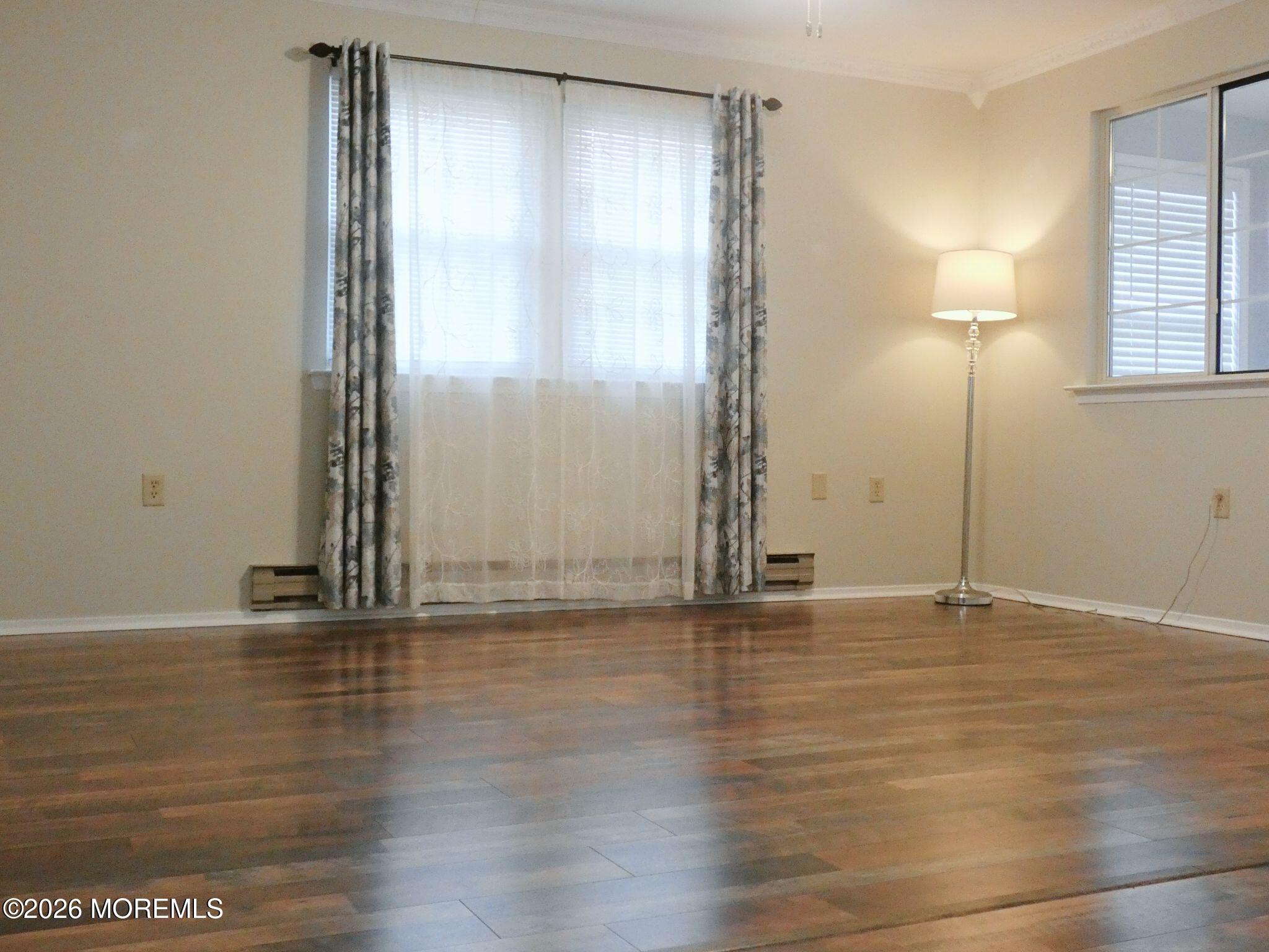 33D Medford Road, Unit A Manchester Township, NJ 08759 - Photo 6 of 24 an empty room with wooden floor and windows