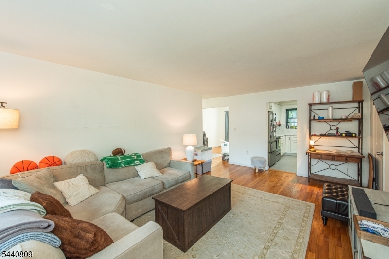 206 Main Street, Unit 42A Millburn, NJ 07041 - Photo 10 of 21 a living room with furniture and a flat screen tv