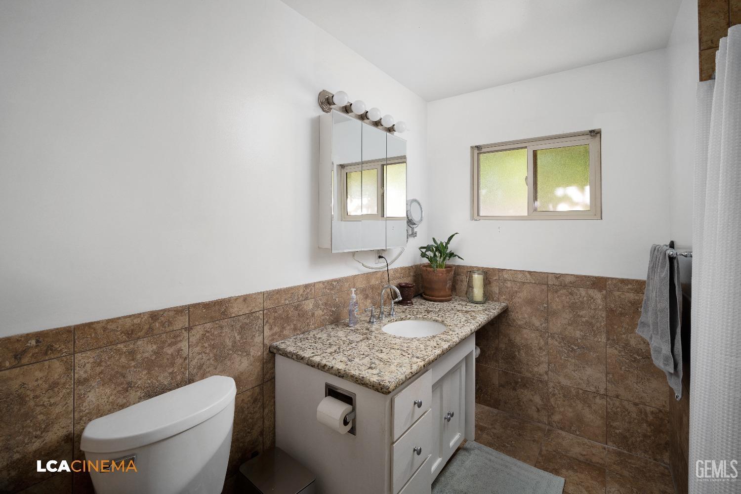 Undisclosed Address Taft, CA 93268 - Photo 12 of 20 a bathroom with a granite countertop sink and a toilet