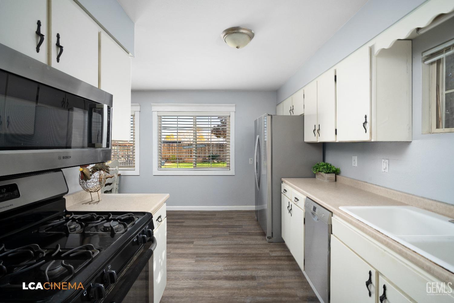 Undisclosed Address Taft, CA 93268 - Photo 8 of 20 a kitchen with stainless steel appliances a stove a sink a stove and cabinets