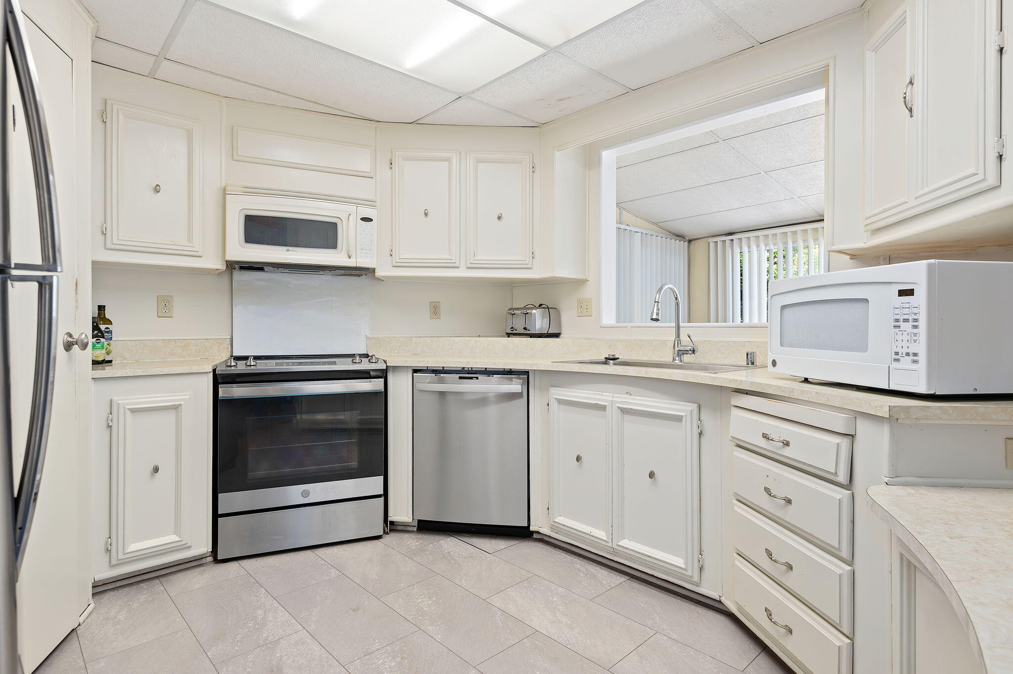 340 Old Mill Road, Unit SPC 12 Santa Barbara, CA 93110 - Photo 12 of 35 a kitchen with white cabinets and white appliances