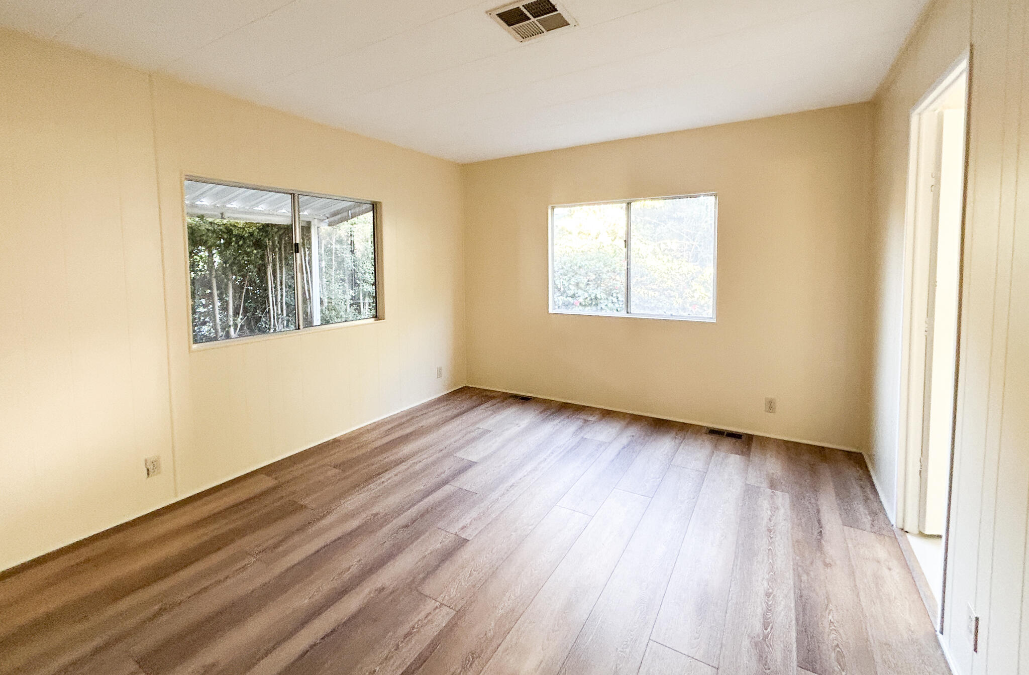 340 Old Mill Road, Unit SPC 12 Santa Barbara, CA 93110 - Photo 16 of 35 a view of an empty room with wooden floor and a window