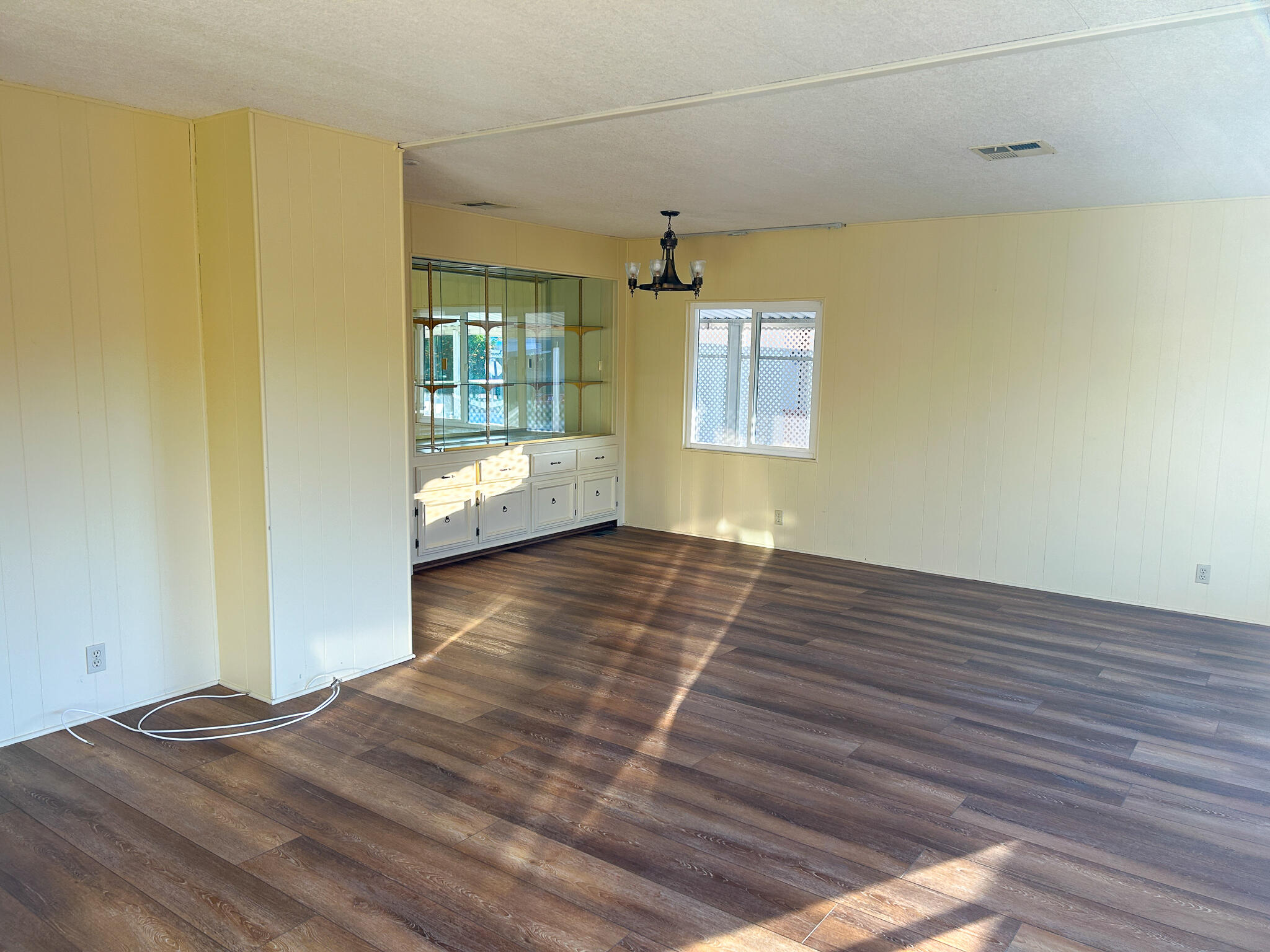 340 Old Mill Road, Unit SPC 12 Santa Barbara, CA 93110 - Photo 5 of 35 a view of an empty room with wooden floor and a window