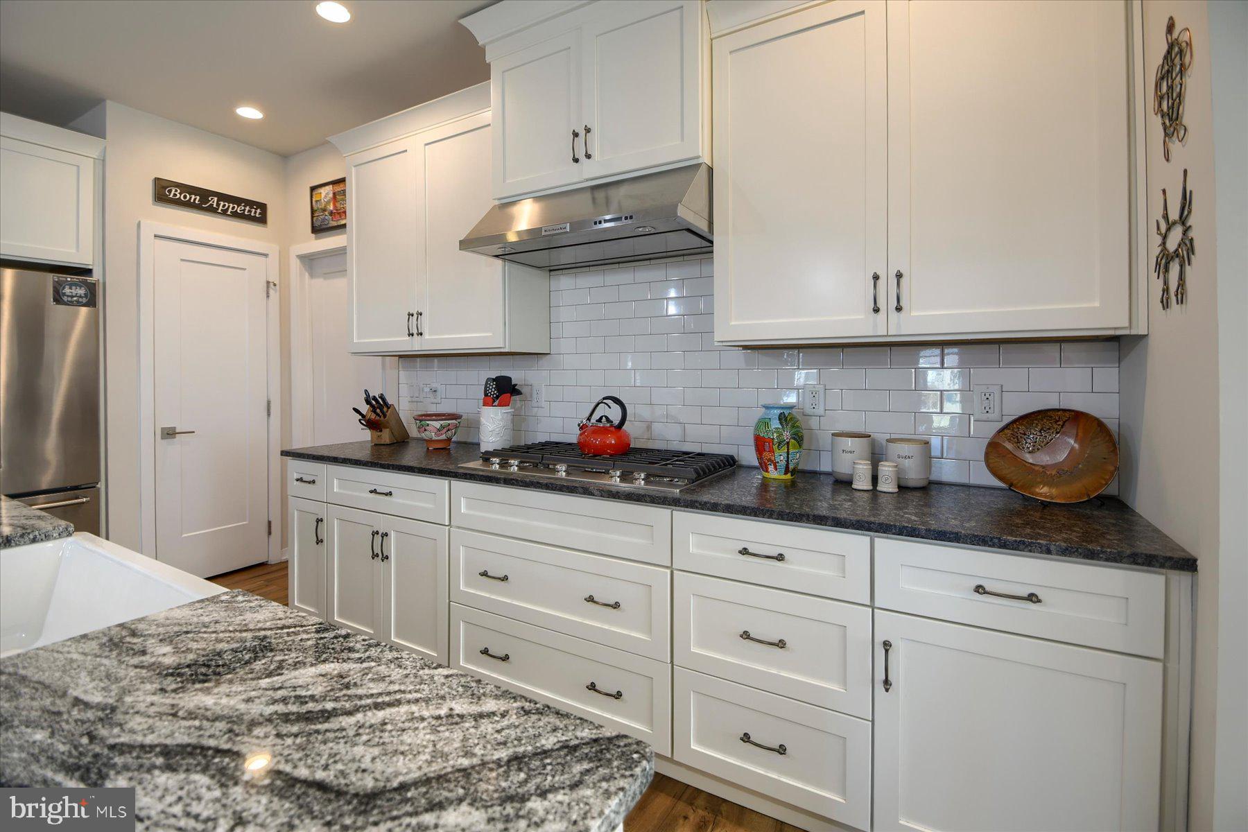 6963 Maple Drive Bath, PA 18014 - Photo 11 of 46 a kitchen with granite countertop white cabinets and stainless steel appliances