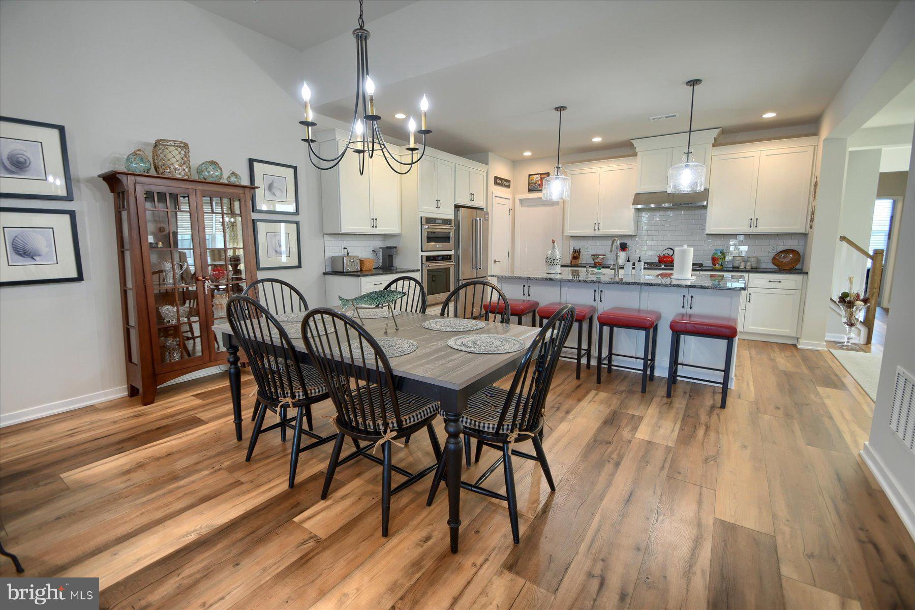 6963 Maple Drive Bath, PA 18014 - Photo 16 of 46 a view of a dining room with furniture and wooden floor