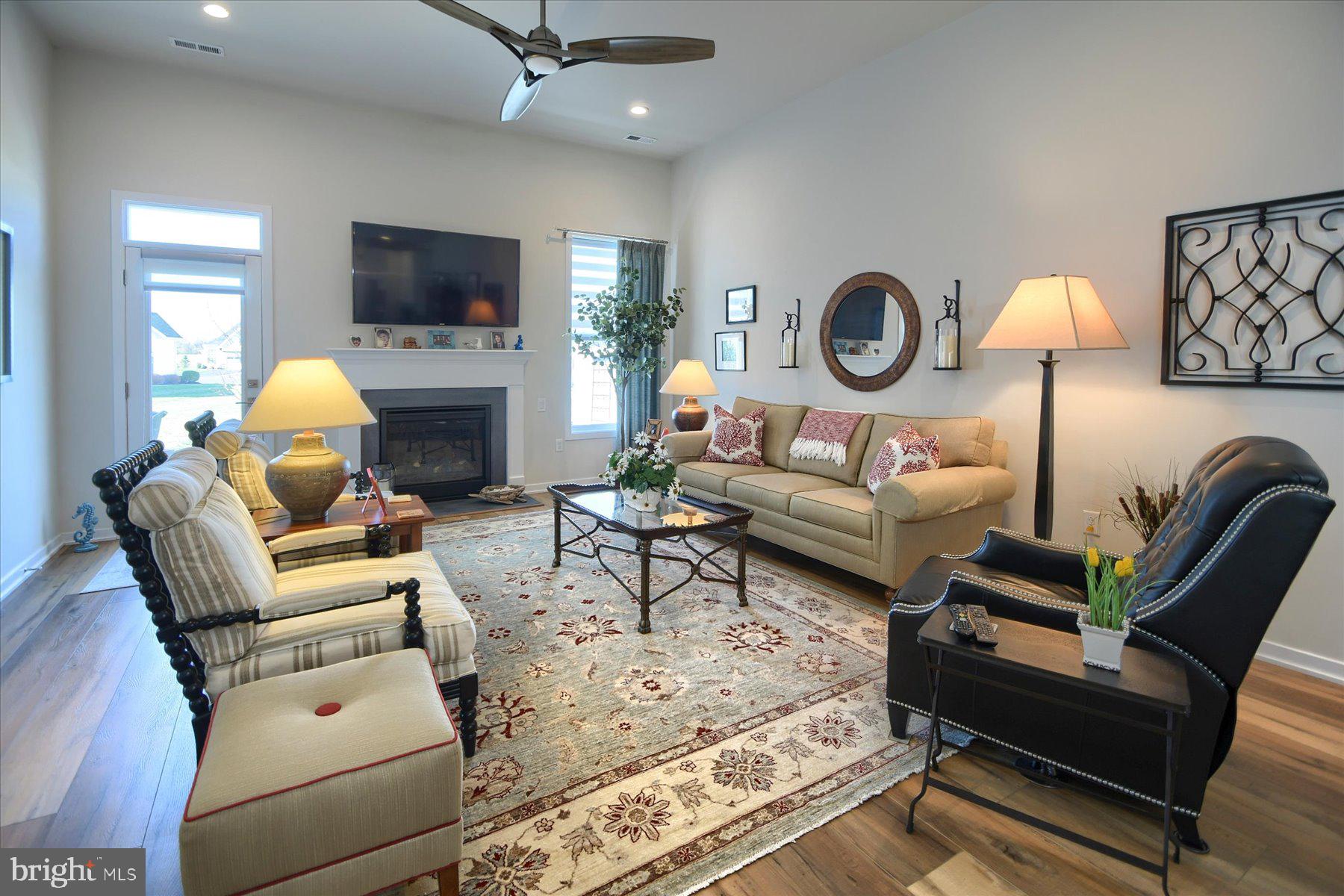 6963 Maple Drive Bath, PA 18014 - Photo 17 of 46 a living room with furniture a fireplace and a flat screen tv