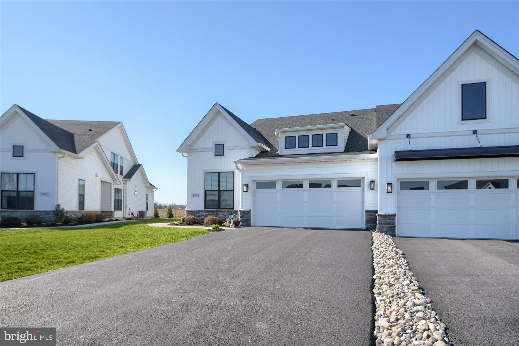 6963 Maple Drive Bath, PA 18014 - Photo 2 of 46 a front view of a house with a yard and garage