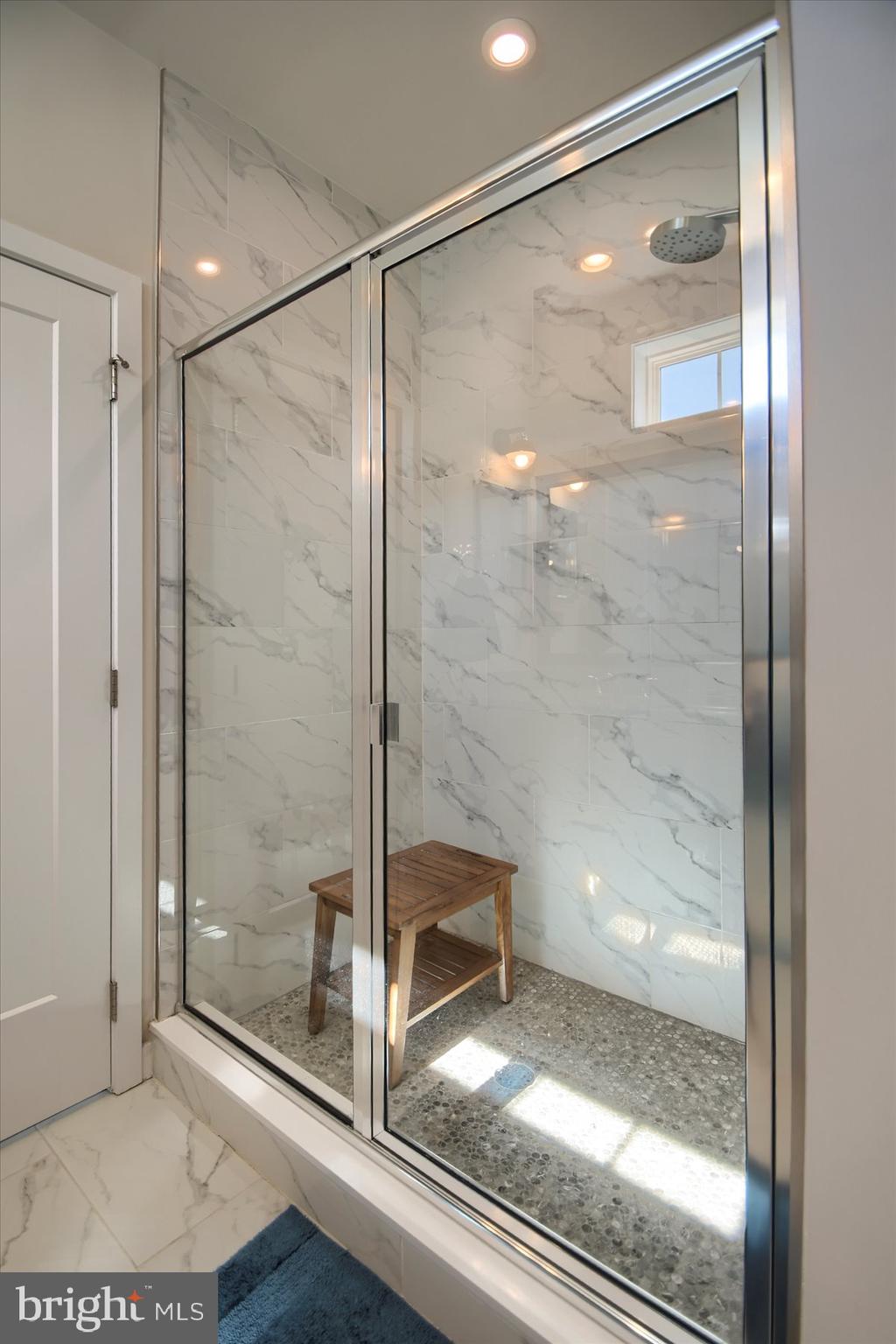 6963 Maple Drive Bath, PA 18014 - Photo 25 of 46 a bathroom with a glass shower door and a window