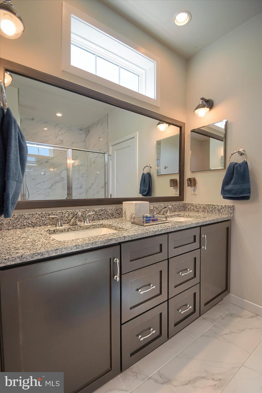 6963 Maple Drive Bath, PA 18014 - Photo 26 of 46 a bathroom with a granite countertop sink and a mirror