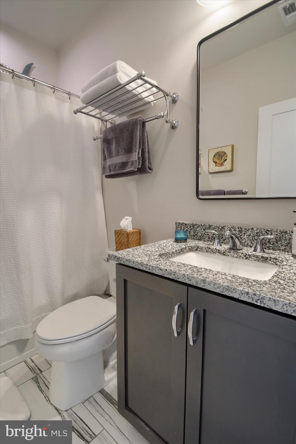6963 Maple Drive Bath, PA 18014 - Photo 27 of 46 a bathroom with a granite countertop sink toilet and a mirror