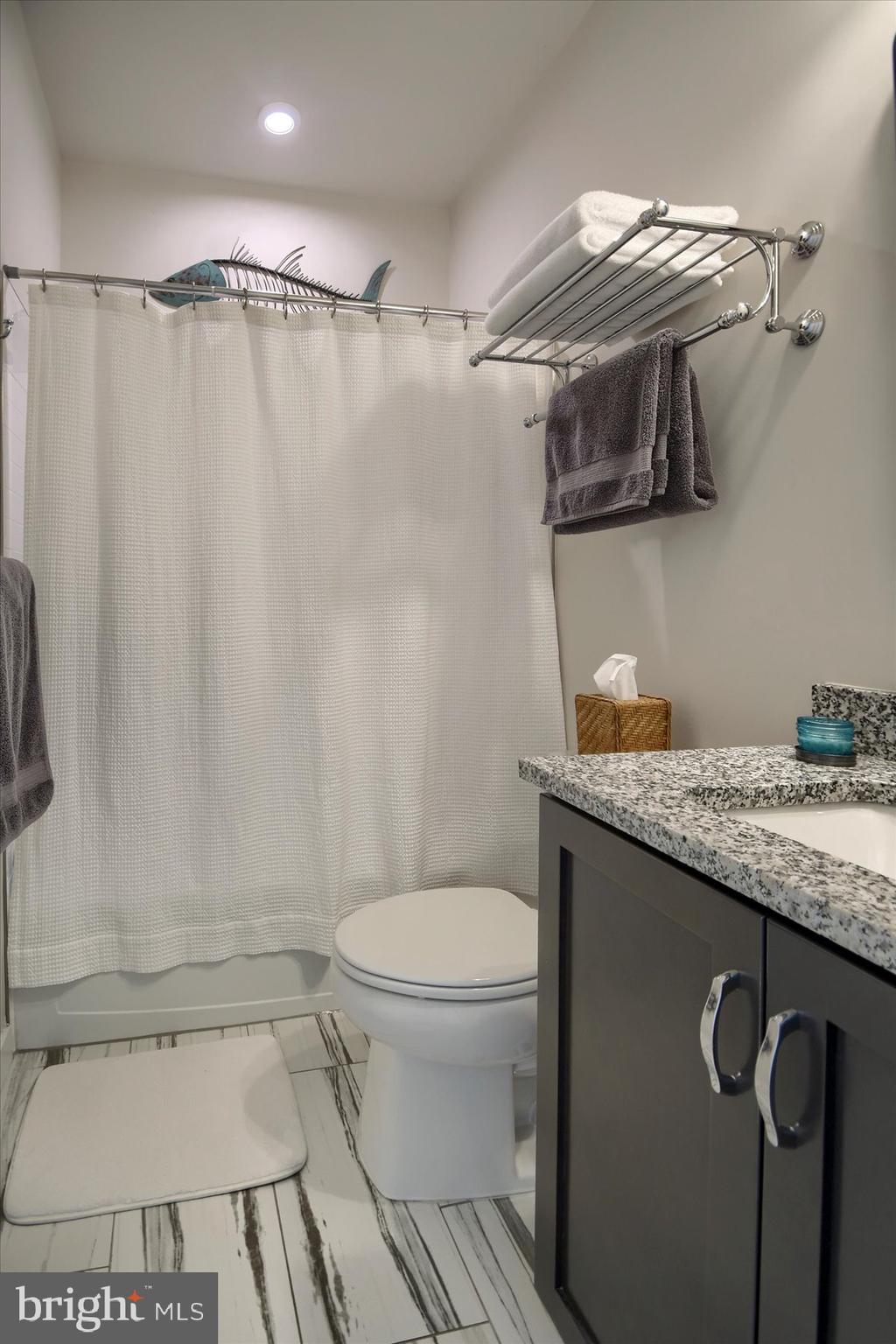 6963 Maple Drive Bath, PA 18014 - Photo 28 of 46 a bathroom with a granite countertop sink toilet and shower