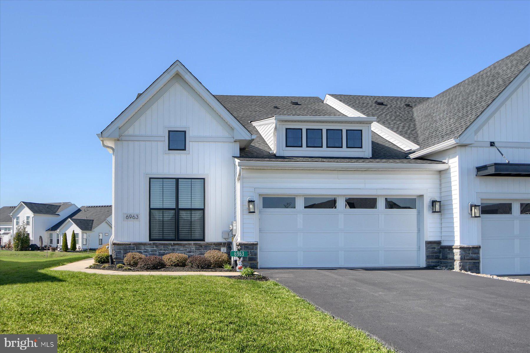 6963 Maple Drive Bath, PA 18014 - Photo 3 of 46 a front view of a house with a yard and garage