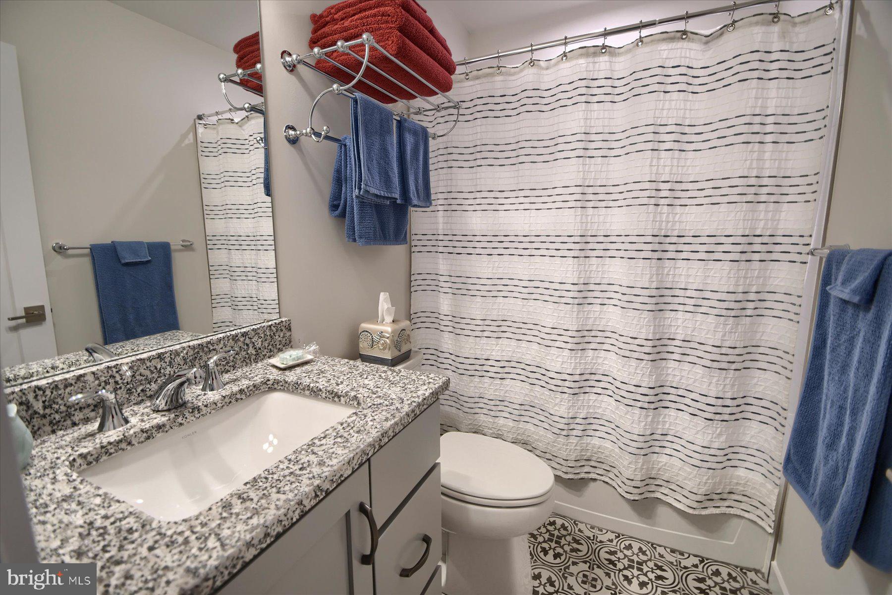 6963 Maple Drive Bath, PA 18014 - Photo 35 of 46 a bathroom with a granite countertop sink a toilet and shower