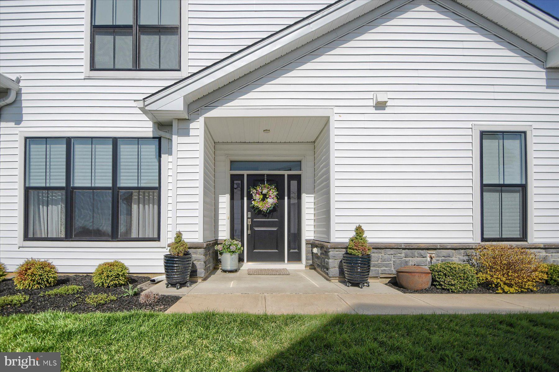 6963 Maple Drive Bath, PA 18014 - Photo 4 of 46 a view of a white house with a small yard and plants