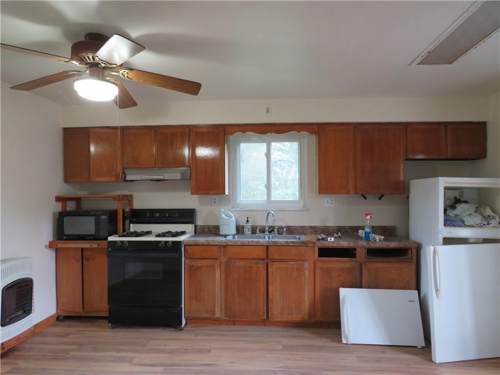 318 Old Ash Road Mercer, PA 16137 - Photo 2 of 15 a kitchen with stainless steel appliances granite countertop a stove a sink and a refrigerator