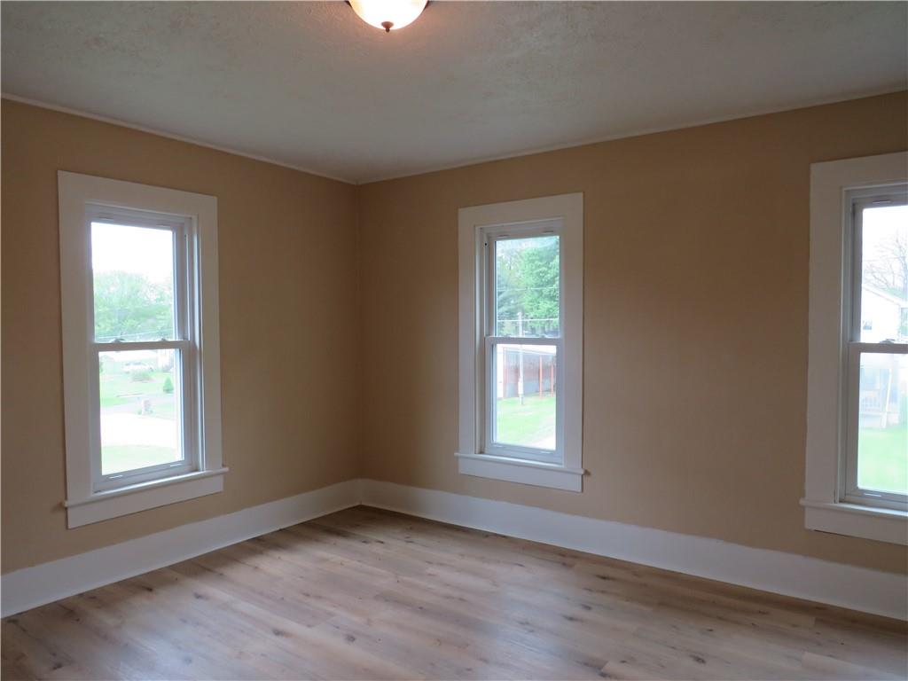 318 Old Ash Road Mercer, PA 16137 - Photo 7 of 15 an empty room with wooden floor and windows