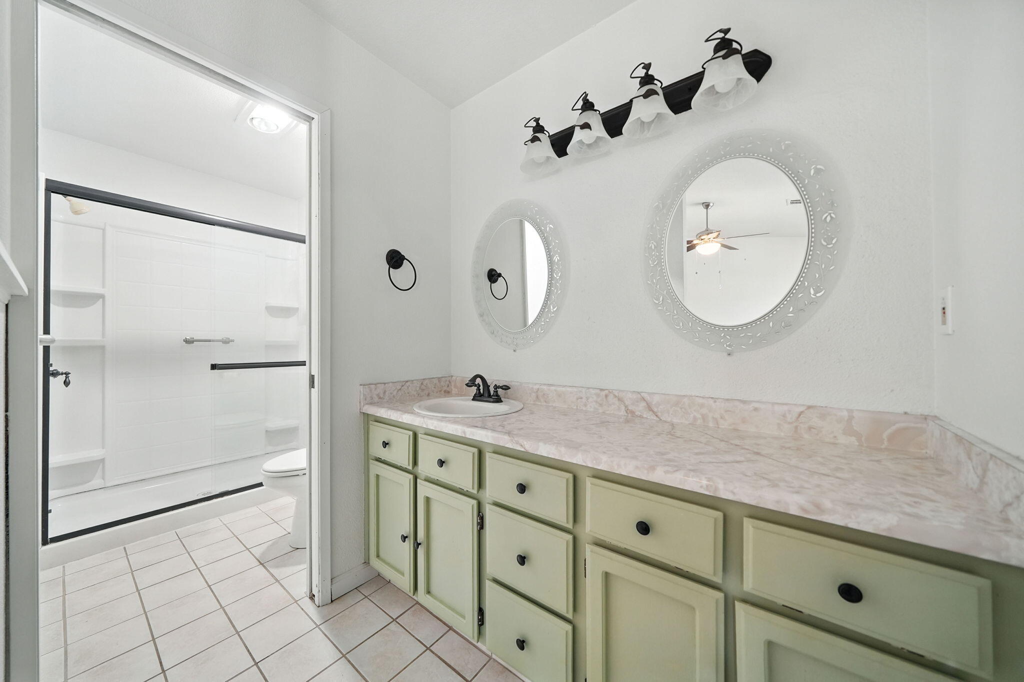 3588 Magnums Way Redding, CA 96003 - Photo 15 of 35 a spacious bathroom with a double vanity sink and a mirror