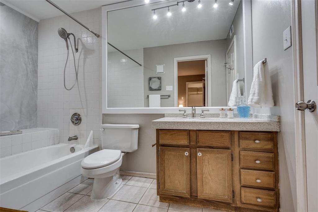 16301 Ledgemont Lane, Unit 262 Addison, TX 75001 - Photo 13 of 25 a bathroom with a sink a toilet and shower