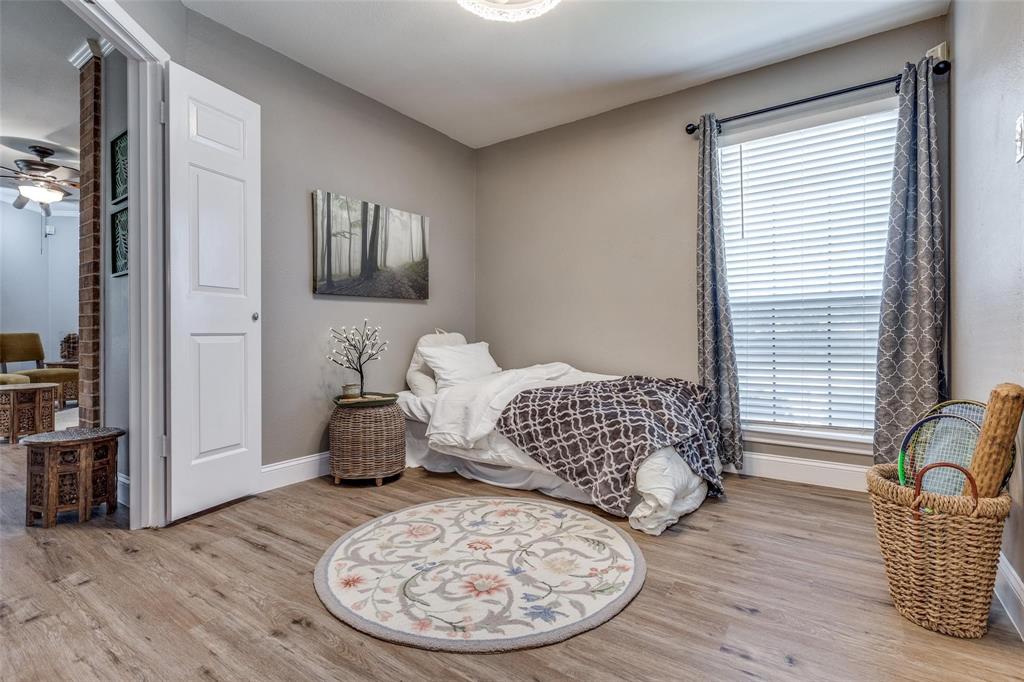 16301 Ledgemont Lane, Unit 262 Addison, TX 75001 - Photo 16 of 25 a bedroom with furniture and wooden floor