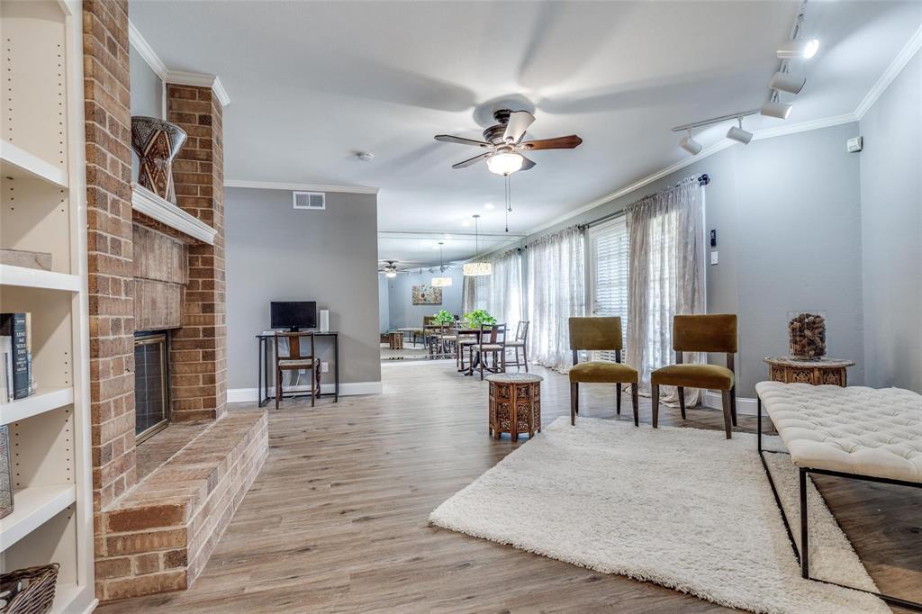 16301 Ledgemont Lane, Unit 262 Addison, TX 75001 - Photo 3 of 25 a living room with fireplace furniture and a wooden floor