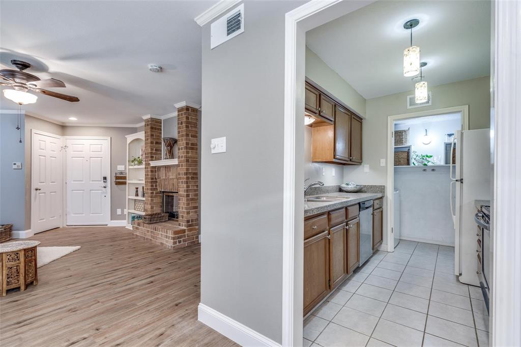 16301 Ledgemont Lane, Unit 262 Addison, TX 75001 - Photo 9 of 25 a kitchen with stainless steel appliances granite countertop a refrigerator and a sink