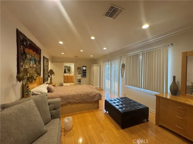 a spacious bedroom with a large bed and furniture
