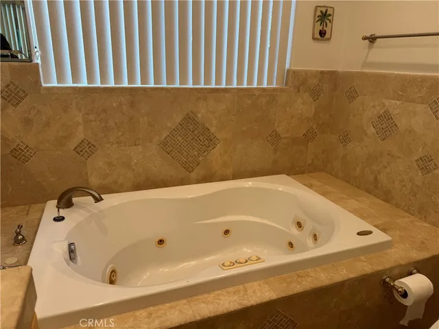 a bathroom with a double vanity sink and a bathtub