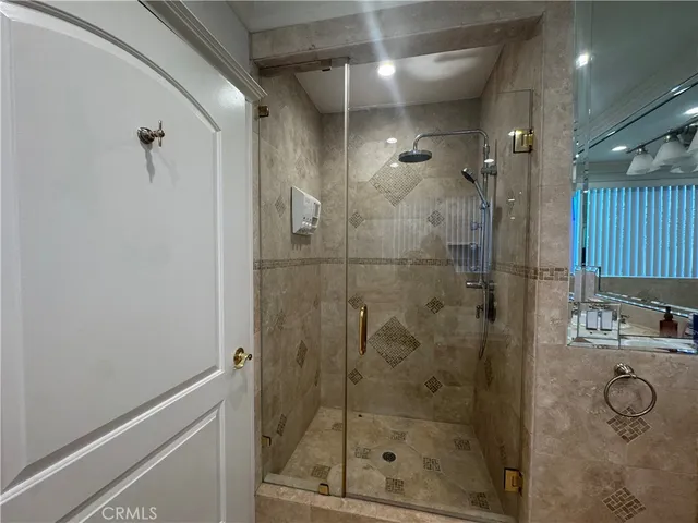 a spacious bedroom with a bed and a flat screen tv