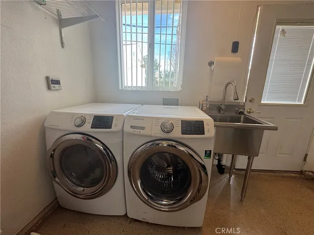 a view of a patio with table and chairs