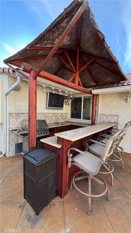 a view of a patio with table and chairs and potted plants
