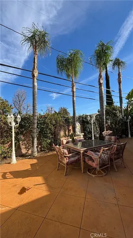 a view of a patio with table and chairs