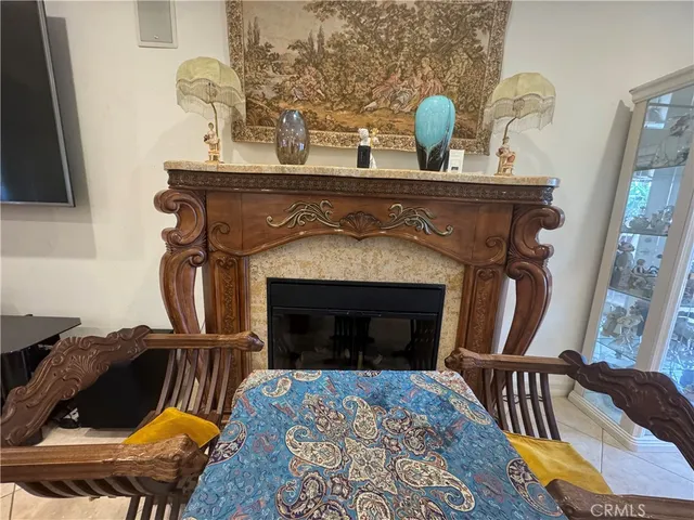 a living room with fireplace furniture and a flat screen tv