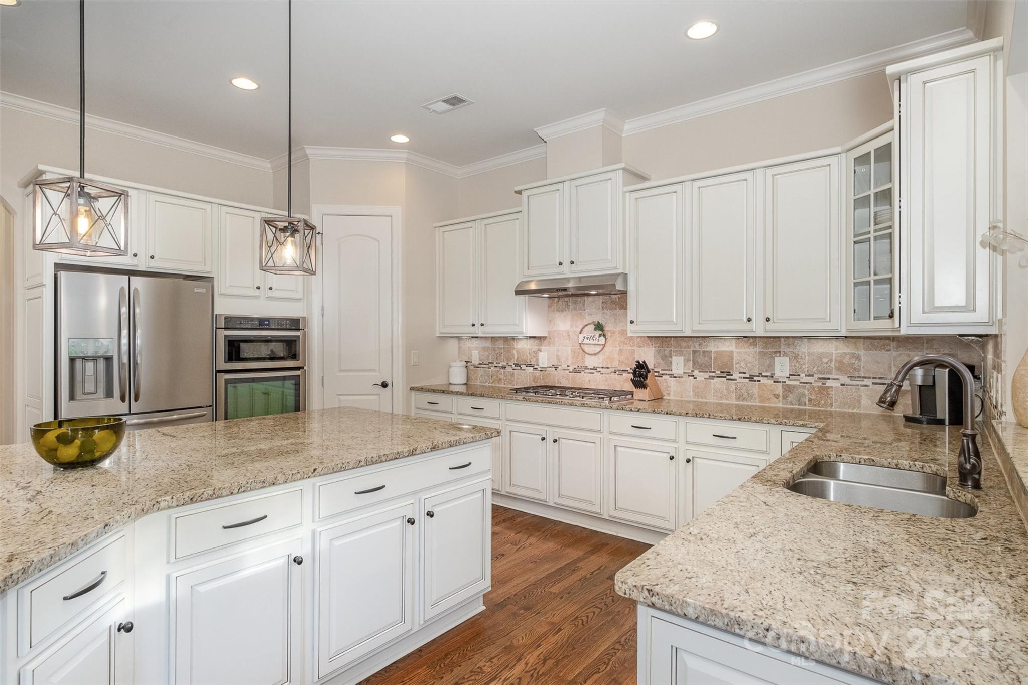 6926 Potter Road Weddington, NC 28104 - Photo 12 of 46 a kitchen with stainless steel appliances granite countertop a sink a stove and refrigerator