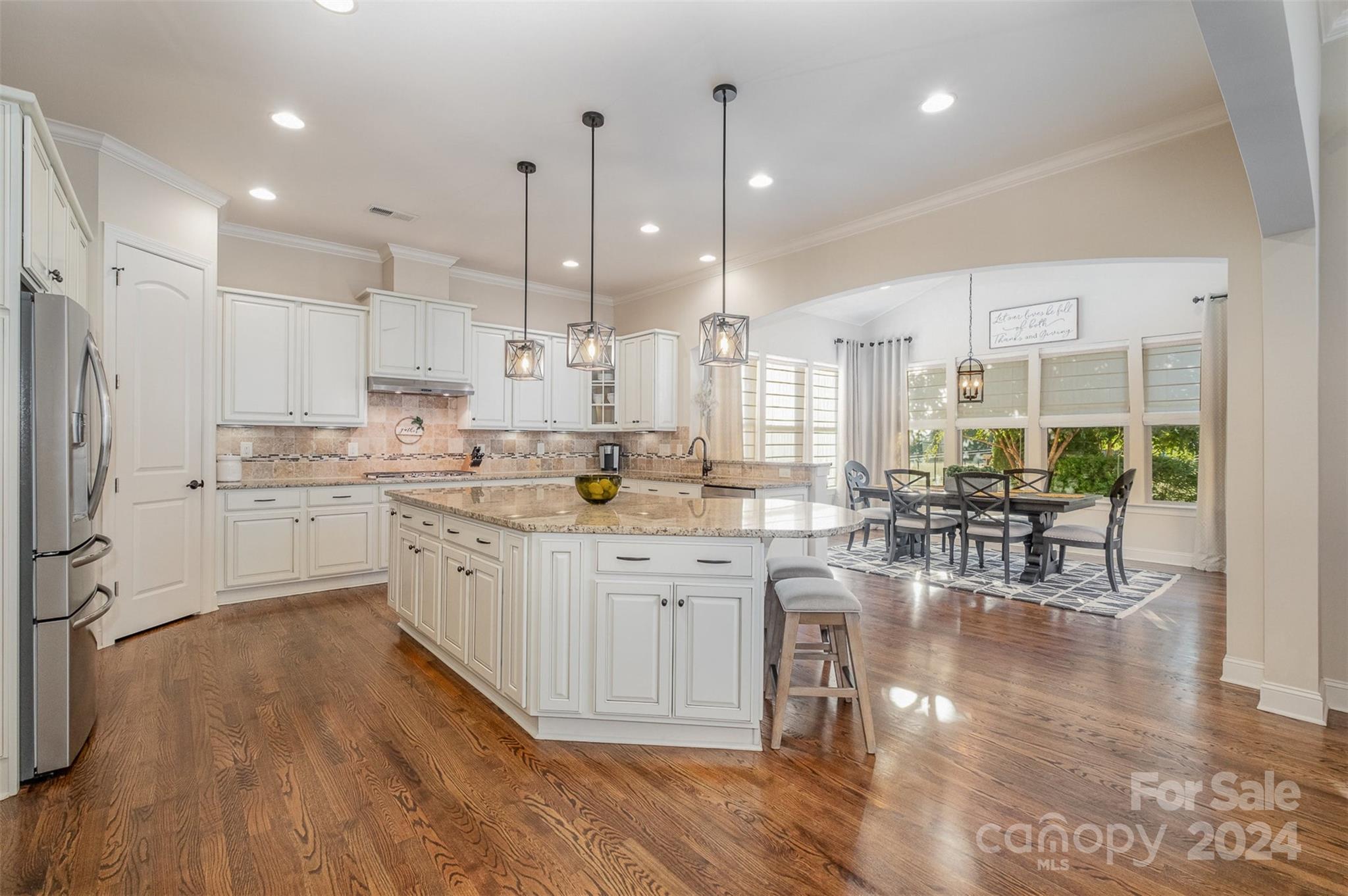 6926 Potter Road Weddington, NC 28104 - Photo 14 of 46 a kitchen with white cabinets and sink