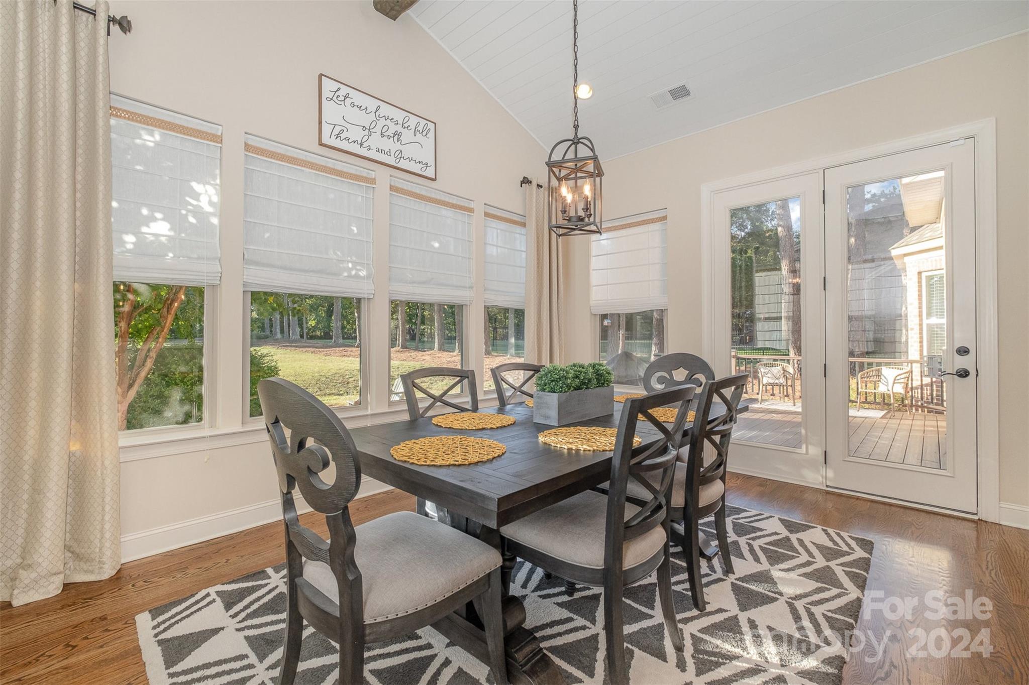 6926 Potter Road Weddington, NC 28104 - Photo 16 of 46 a view of a dining room with furniture wooden floor and chandelier