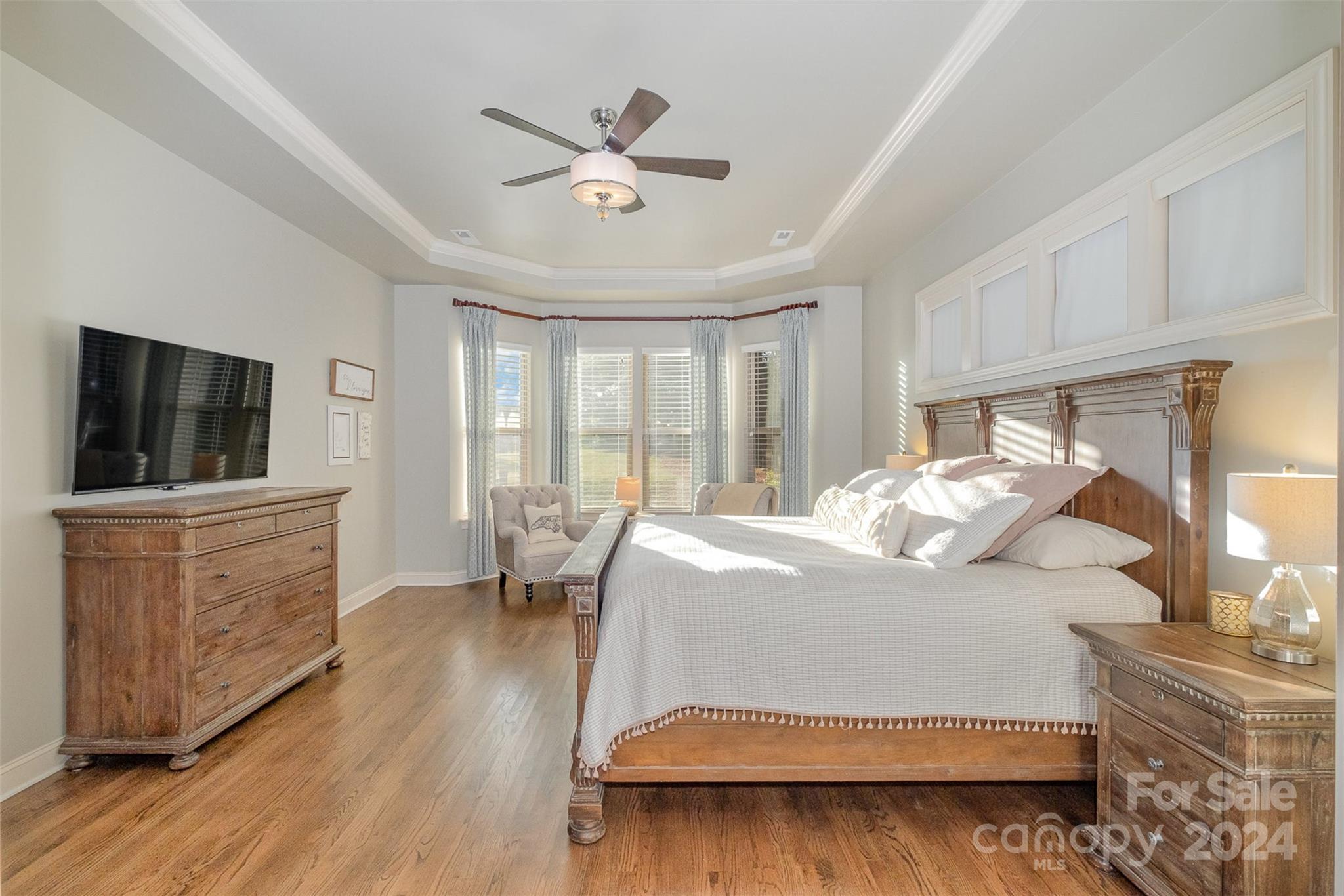 6926 Potter Road Weddington, NC 28104 - Photo 20 of 46 a bedroom with a large bed and a flat tv screen on dresser