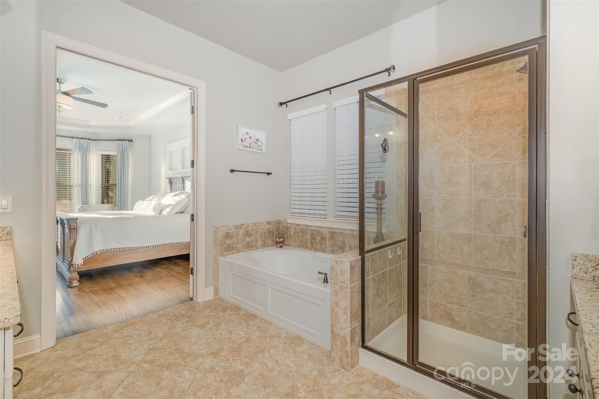 6926 Potter Road Weddington, NC 28104 - Photo 22 of 46 a bathroom with a bathtub and a shower