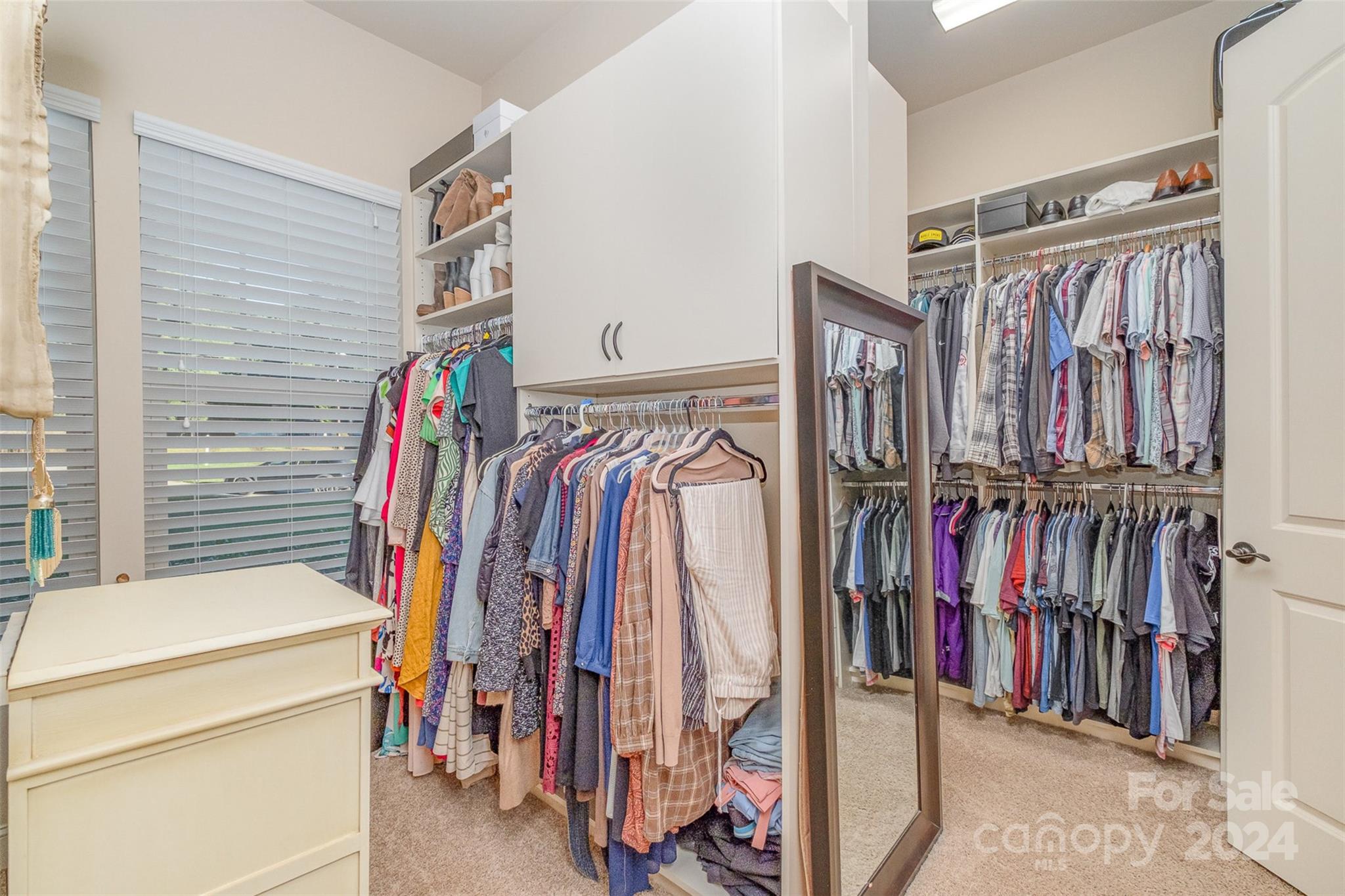 6926 Potter Road Weddington, NC 28104 - Photo 24 of 46 a view of walk in closet with clothes