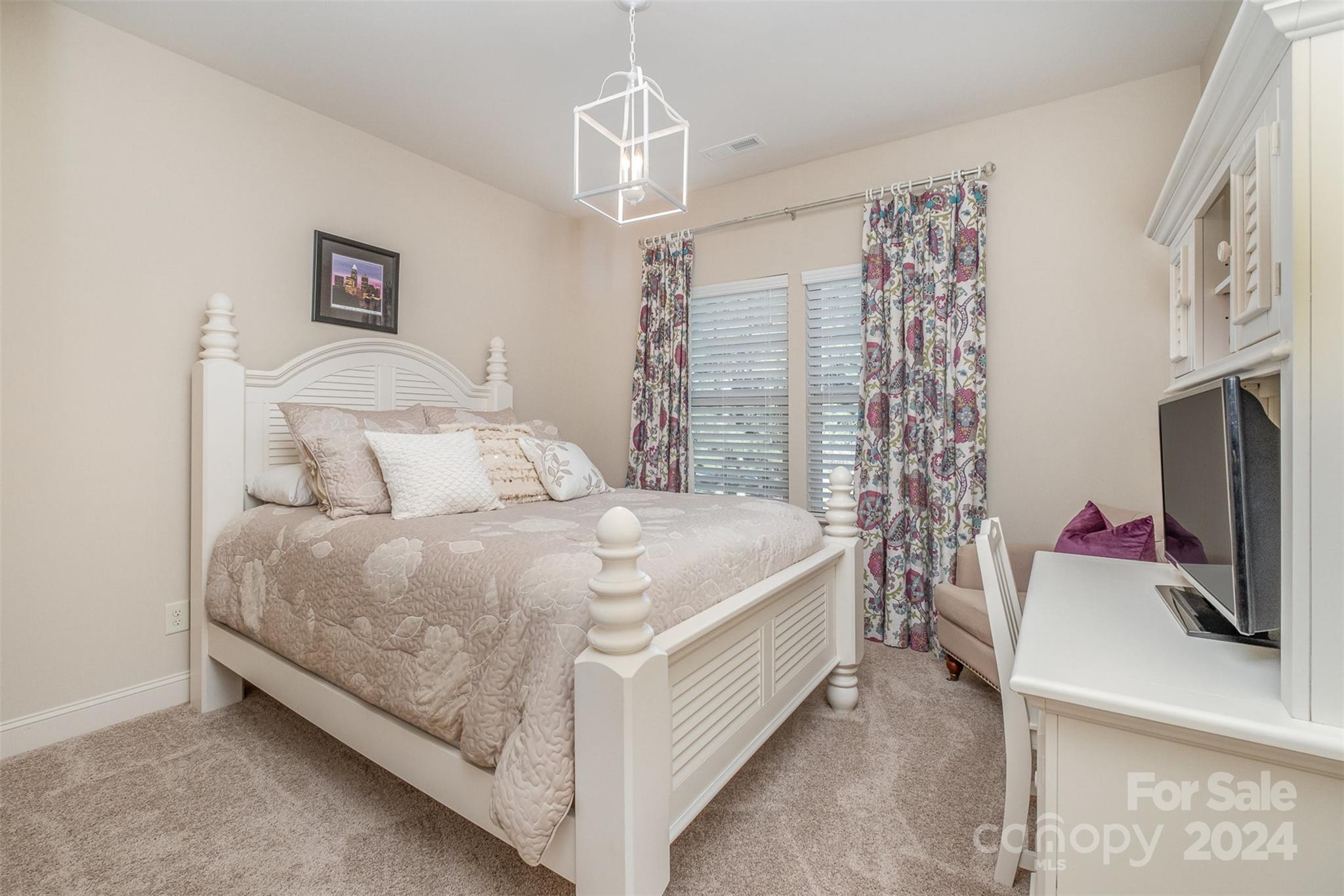 6926 Potter Road Weddington, NC 28104 - Photo 26 of 46 a large bed sitting in a bedroom next to a window and a flat tv screen