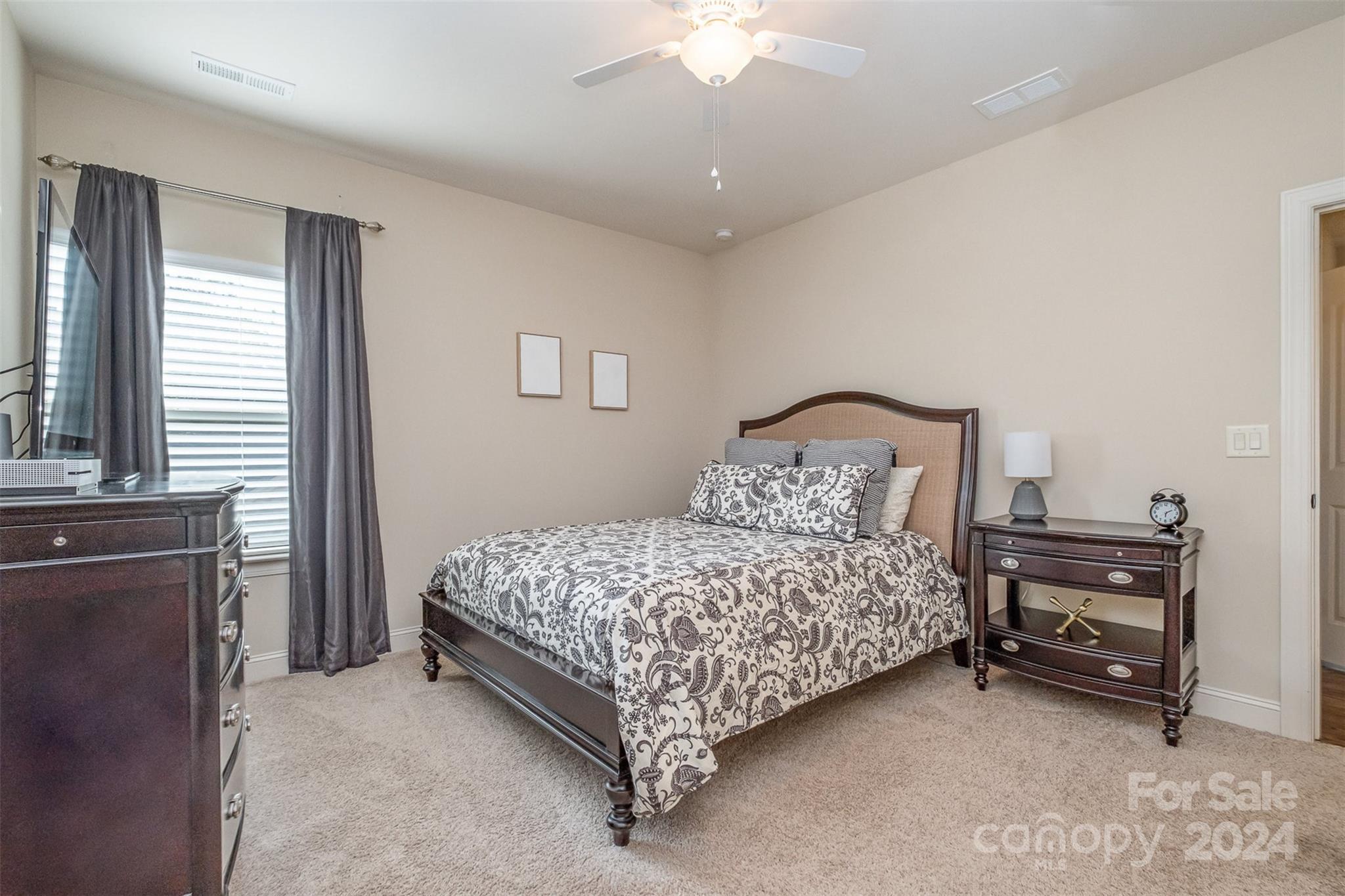 6926 Potter Road Weddington, NC 28104 - Photo 29 of 46 a bedroom with a bed and a chandelier