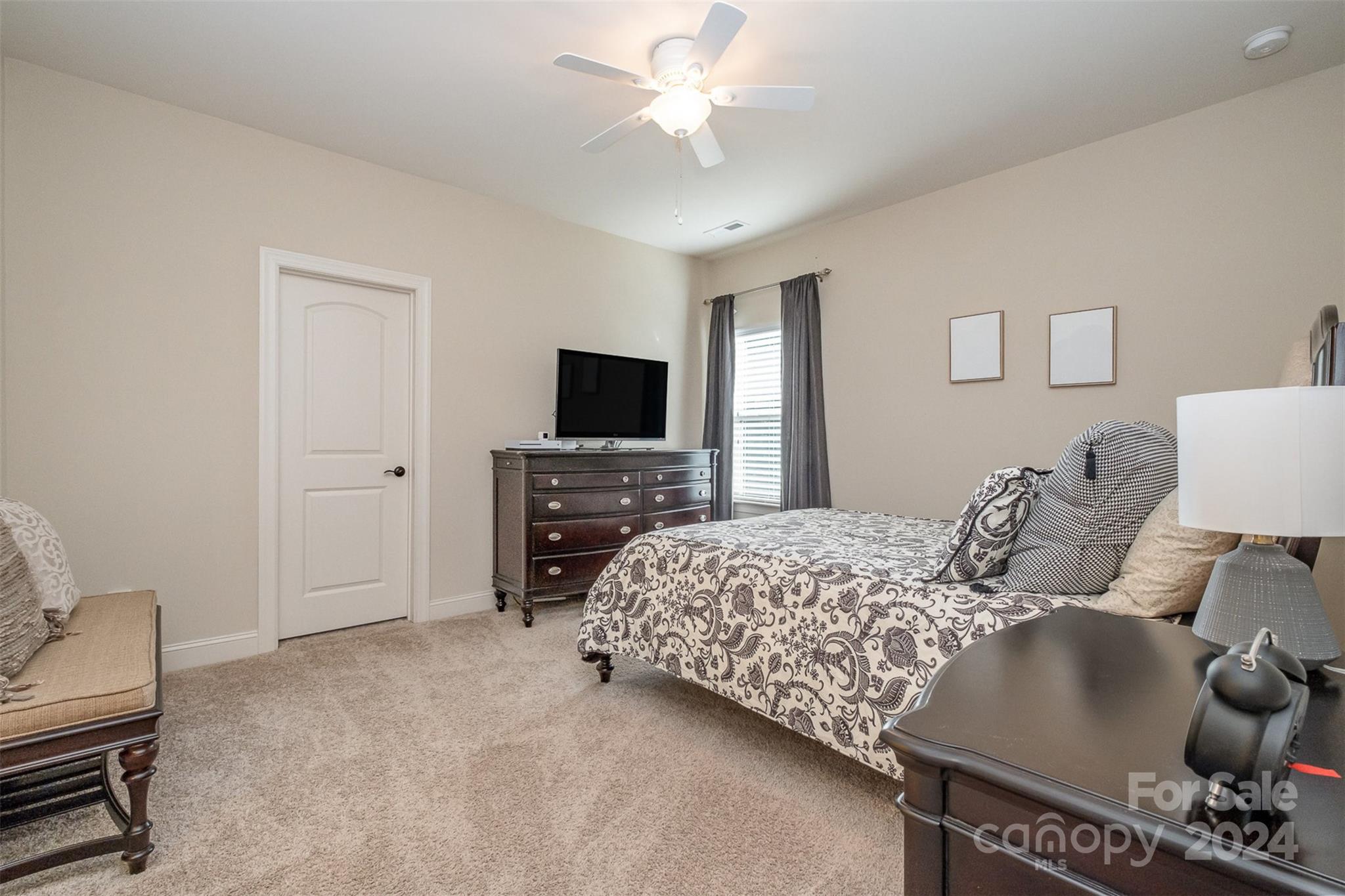 6926 Potter Road Weddington, NC 28104 - Photo 30 of 46 a bedroom with a bed and a flat screen tv
