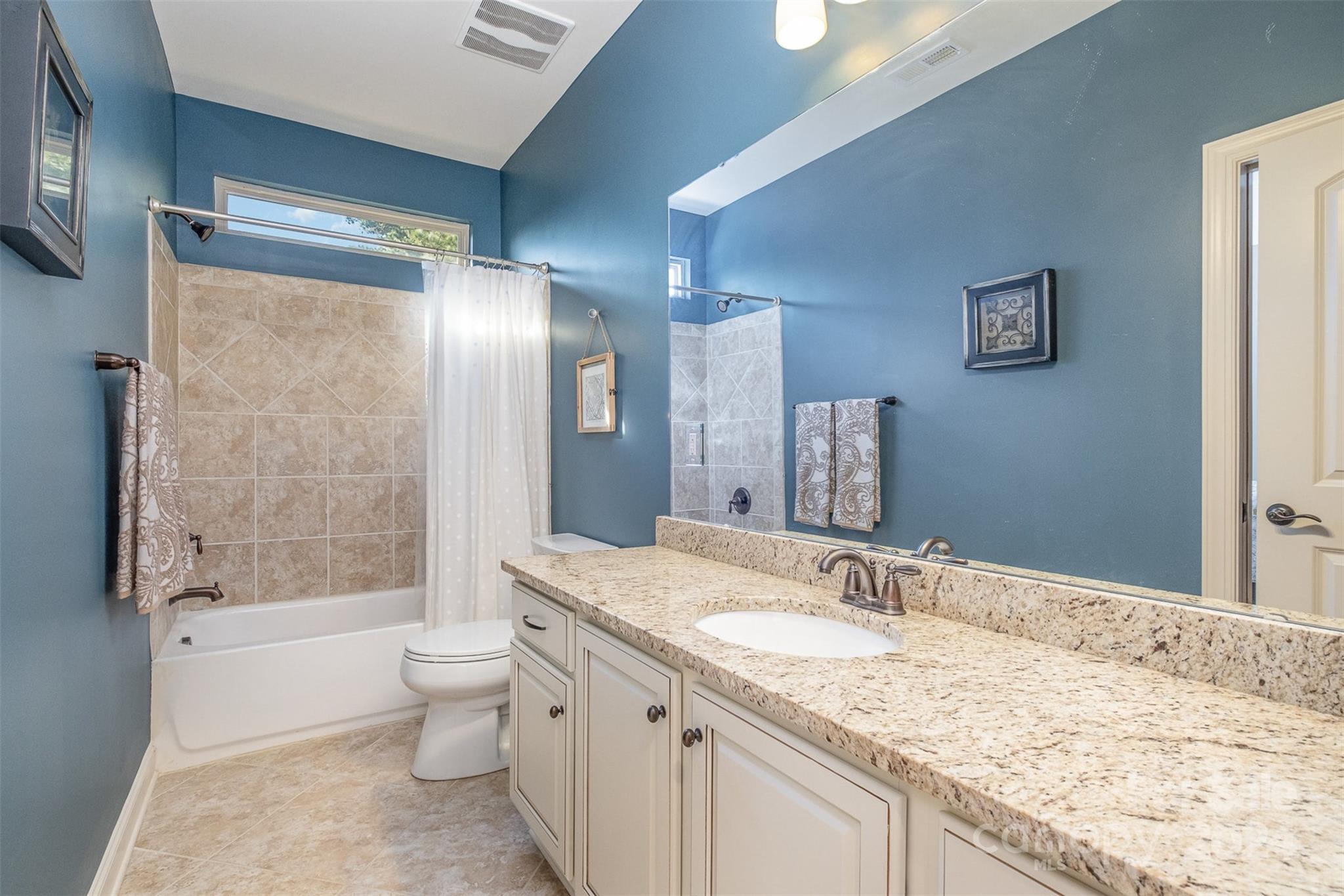 6926 Potter Road Weddington, NC 28104 - Photo 33 of 46 a bathroom with a granite countertop sink toilet and shower