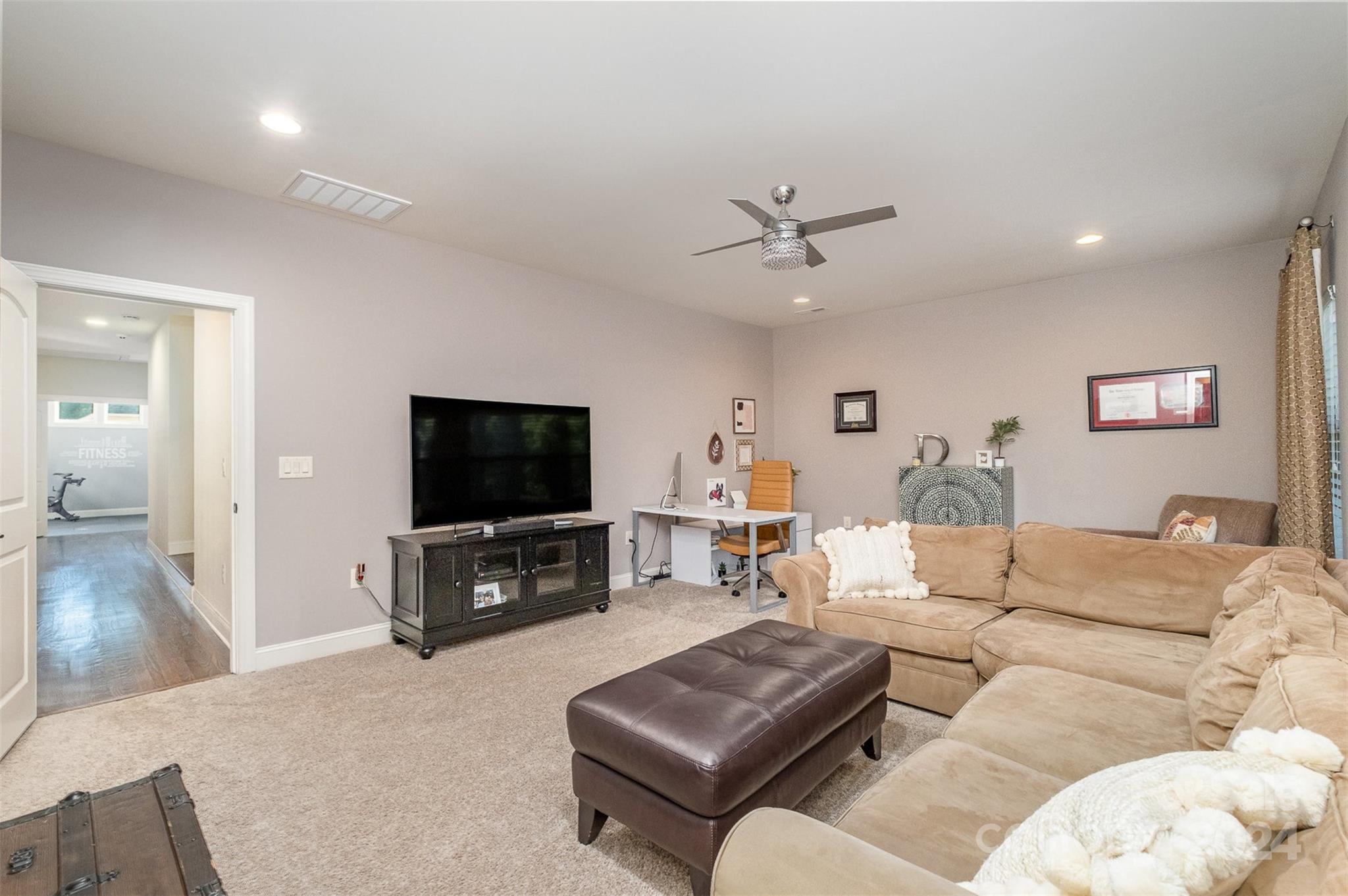 6926 Potter Road Weddington, NC 28104 - Photo 38 of 46 a living room with furniture and a flat screen tv