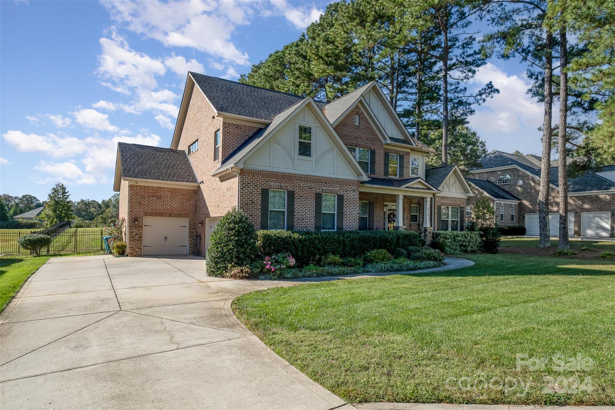 6926 Potter Road Weddington, NC 28104 - Photo 43 of 46 a front view of a house with a yard and garage
