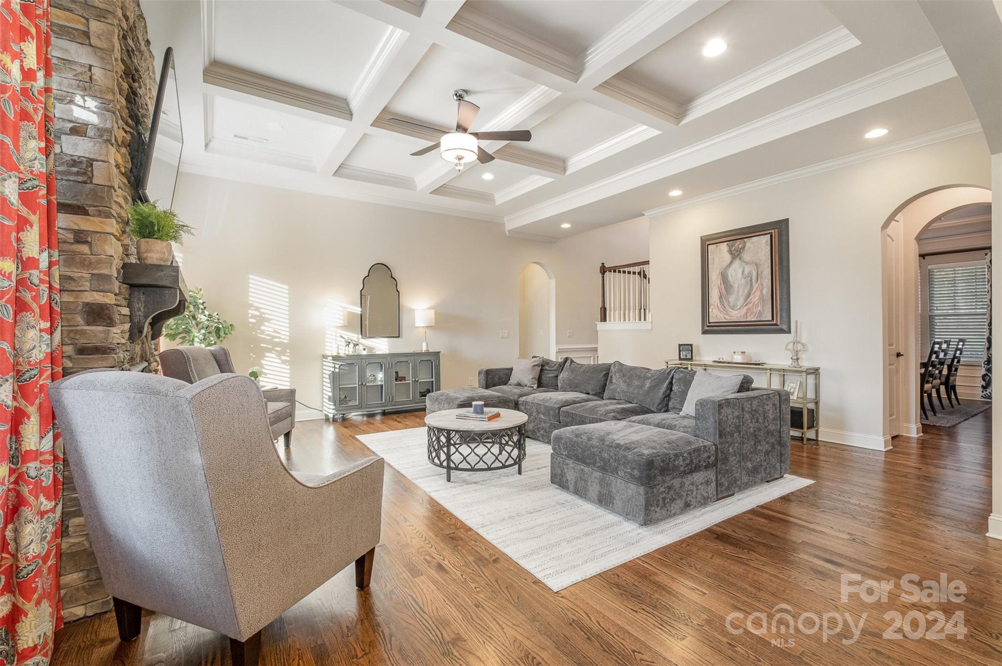 6926 Potter Road Weddington, NC 28104 - Photo 8 of 46 a living room with furniture a fireplace and a chandelier