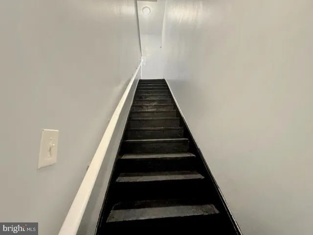 a utility room with wooden floor washer and dryer