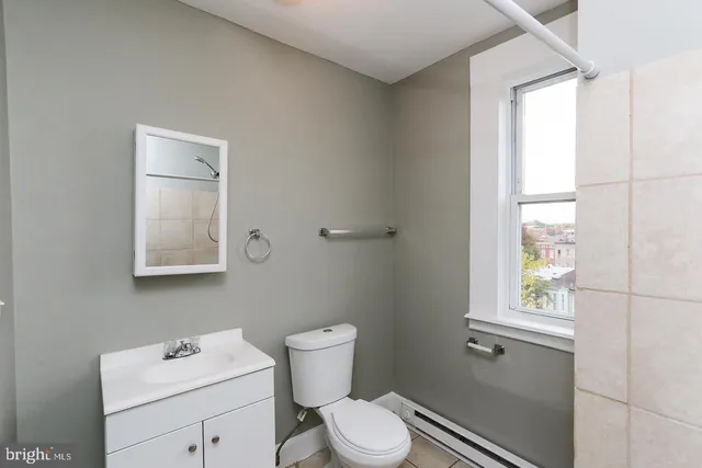 a white toilet sitting next to a shower curtain