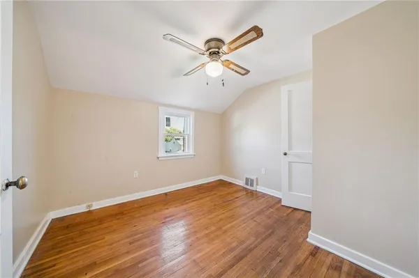 a view of a hallway with a window and a ceiling fan