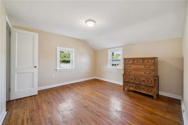 an empty room with furniture and wooden floor